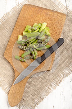 Cut Ã¢â¬â¹Ã¢â¬â¹green asparagus on a wooden board